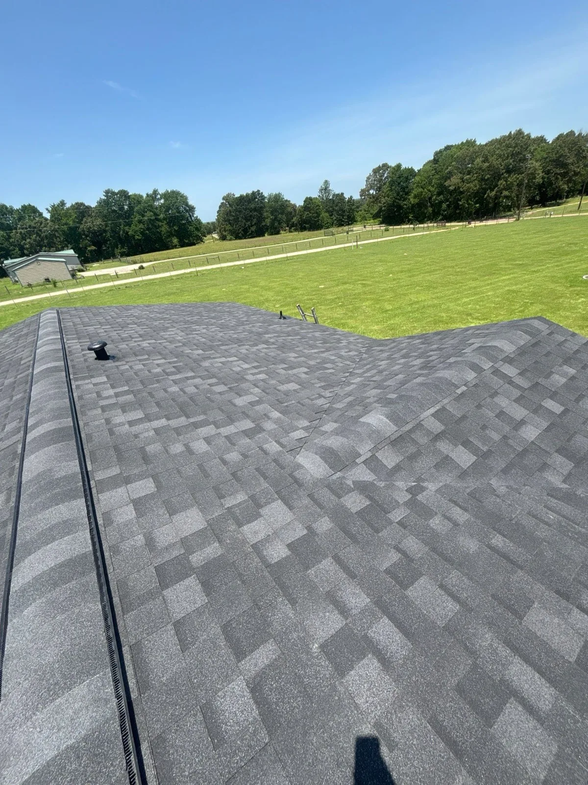 Valley and hip detail on a new architectural shingle roof installed by Faith Roofing Group
